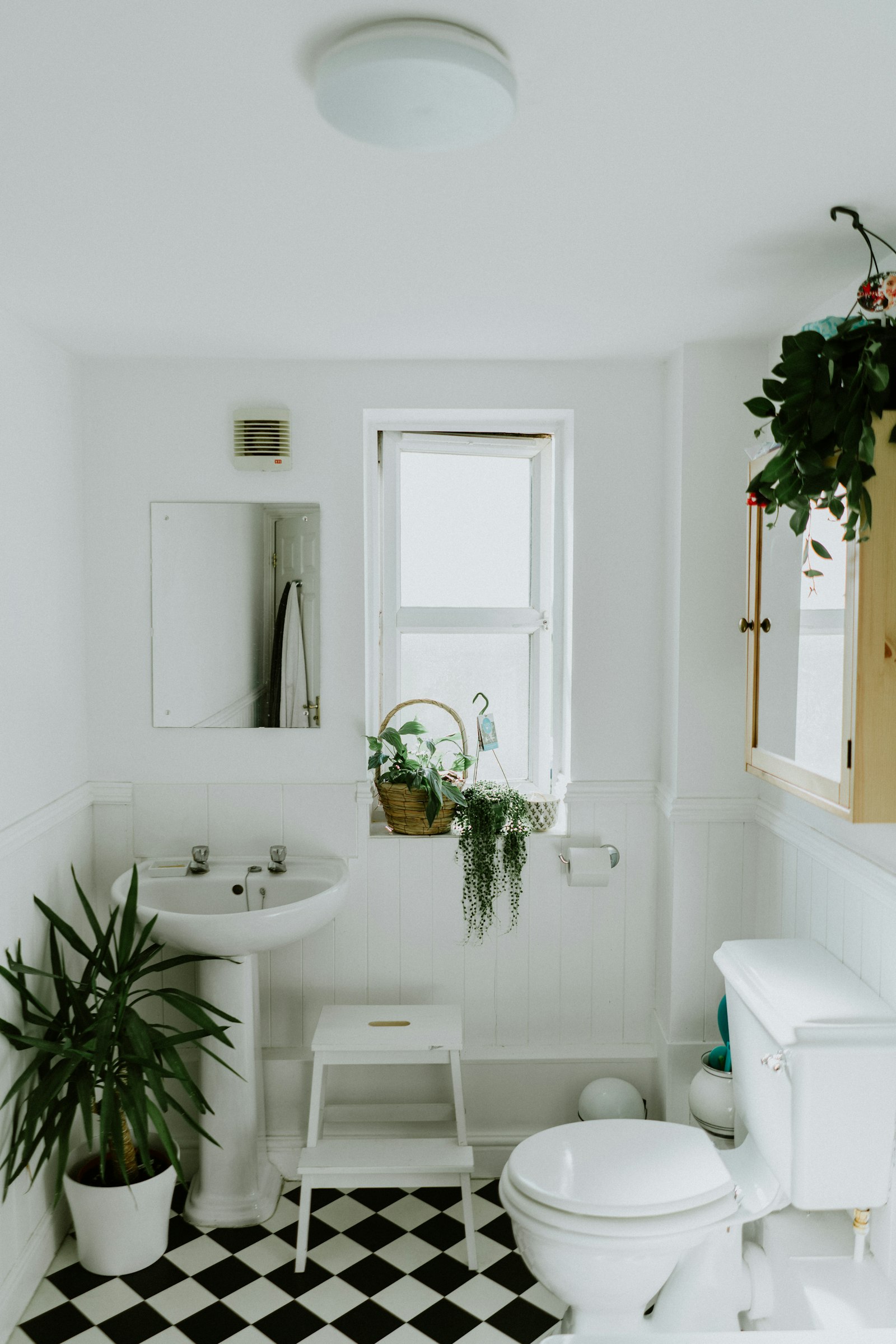 Beautifully remodeled modern bathroom with marble tile, freestanding tub, and natural light